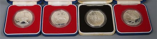 Four UK commemorative silver coins, cased